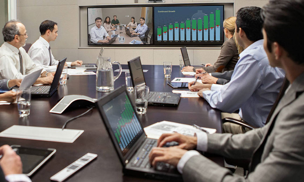 Employees in a meeting using Audio Video Conferencing
