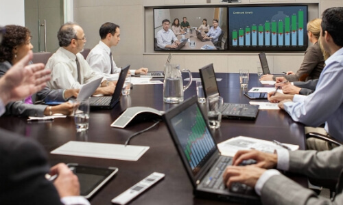 Employees in a meeting using audio video conferencing